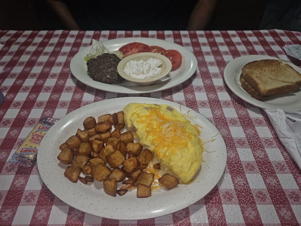 Plates of home-style breakfast food on a table.